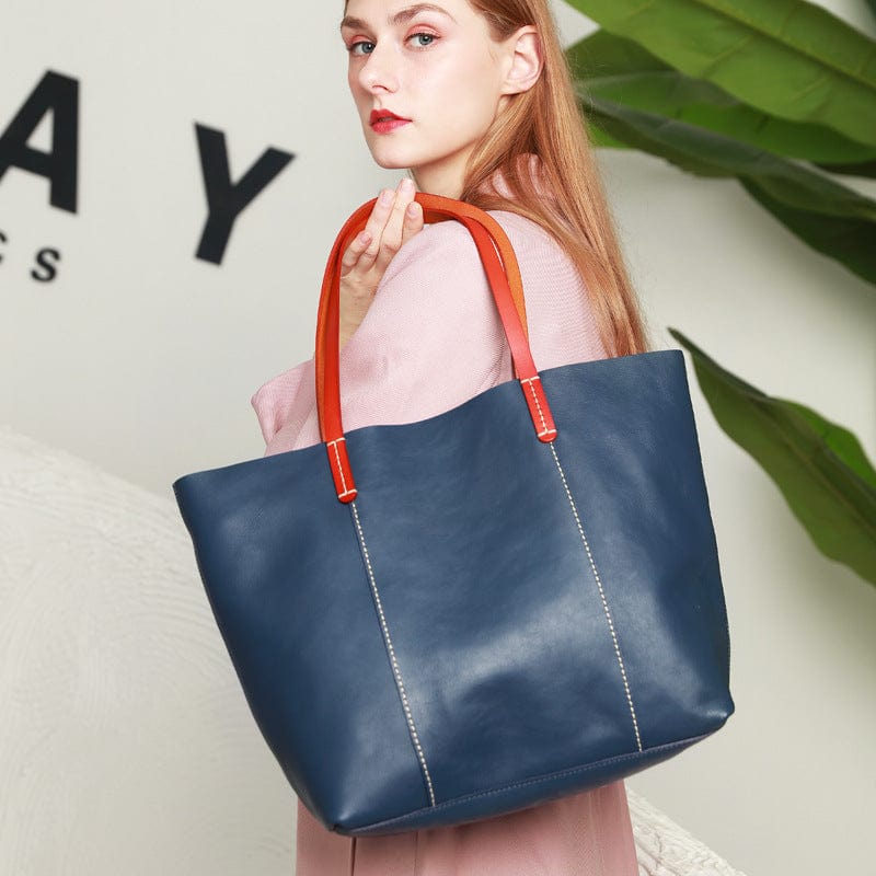 a woman carrying a blue leather tote bag3