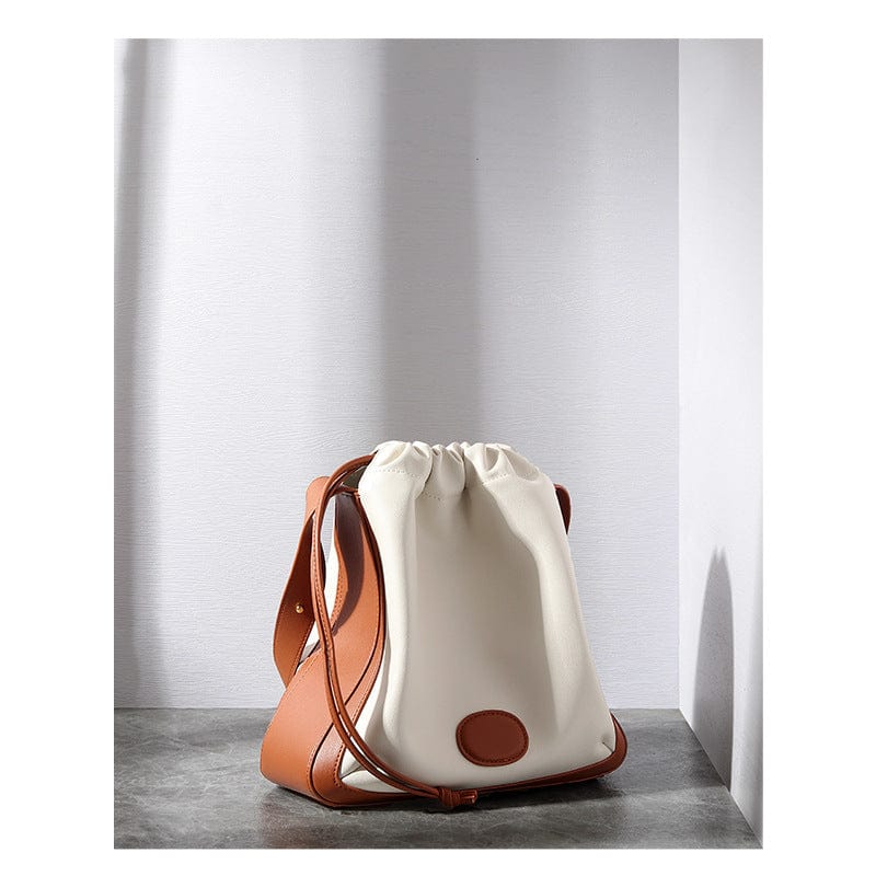 a white and brown purse sitting on top of a table