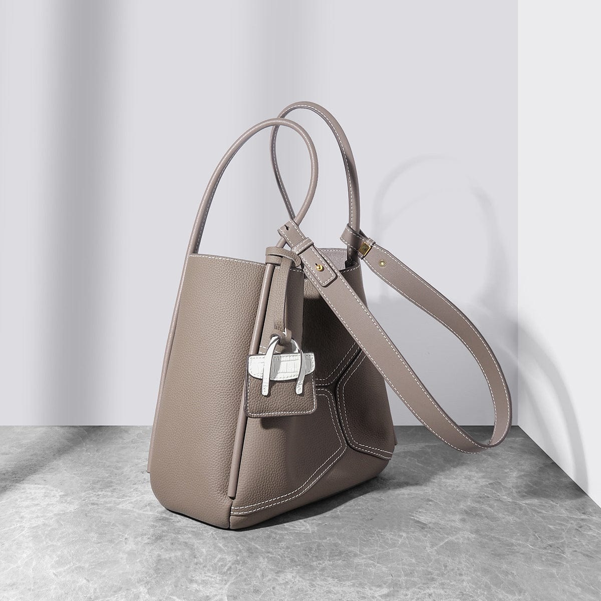 a handbag sitting on top of a table next to a wall