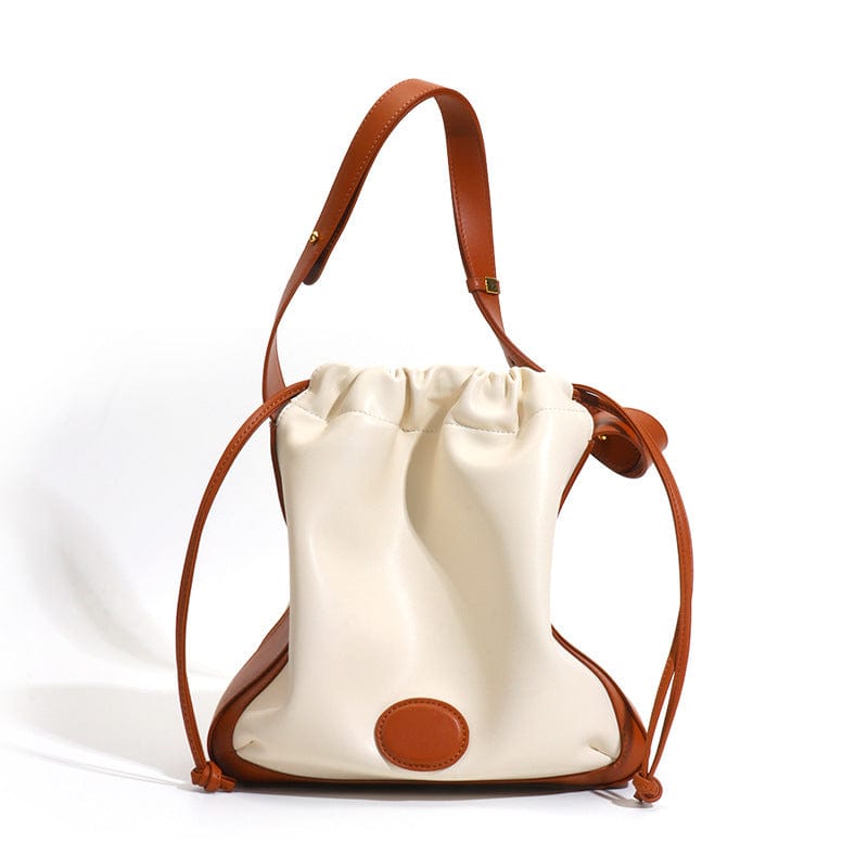 a white purse with a brown handle on a white background