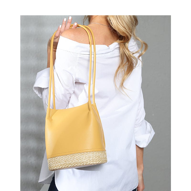 a woman holding a yellow purse in her right hand 5