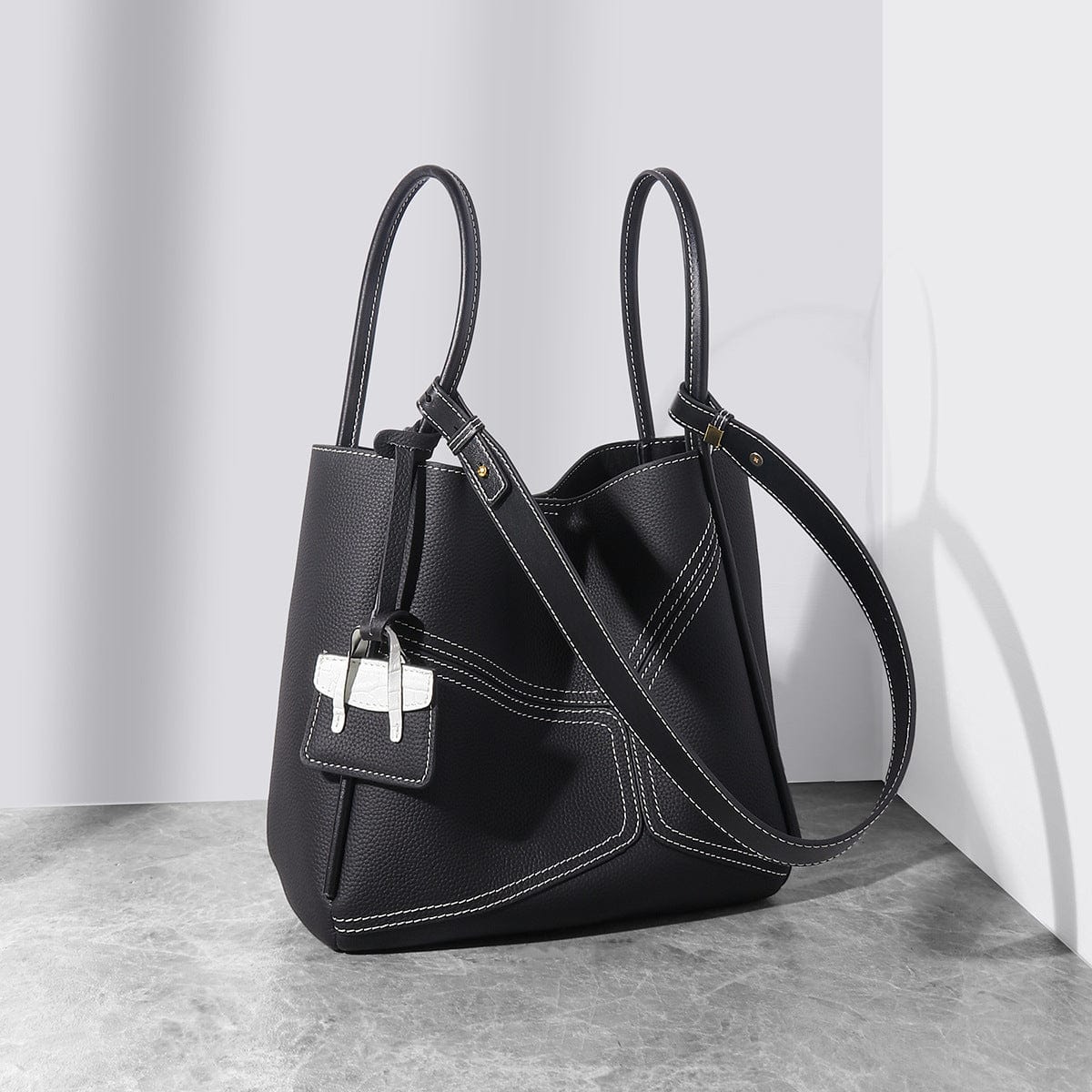 a black handbag with a white cross on it